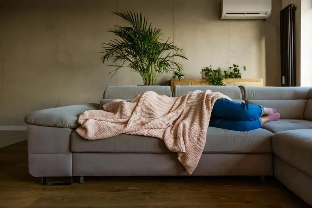 sick person on couch under blanket vzOhDg.width .jpg