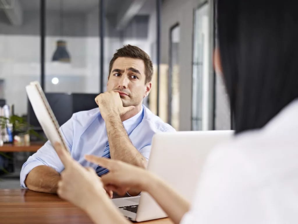 skeptical interviewer looking at interviewee .width AiEaj.jpg
