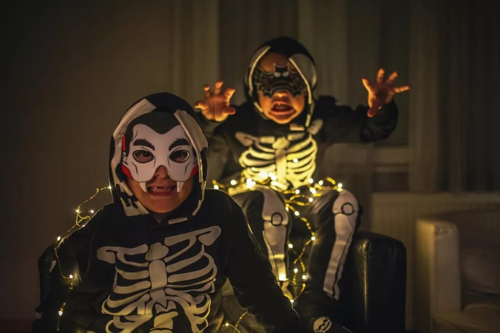 two young boys in Halloween costumes making s.width otPBj.jpg