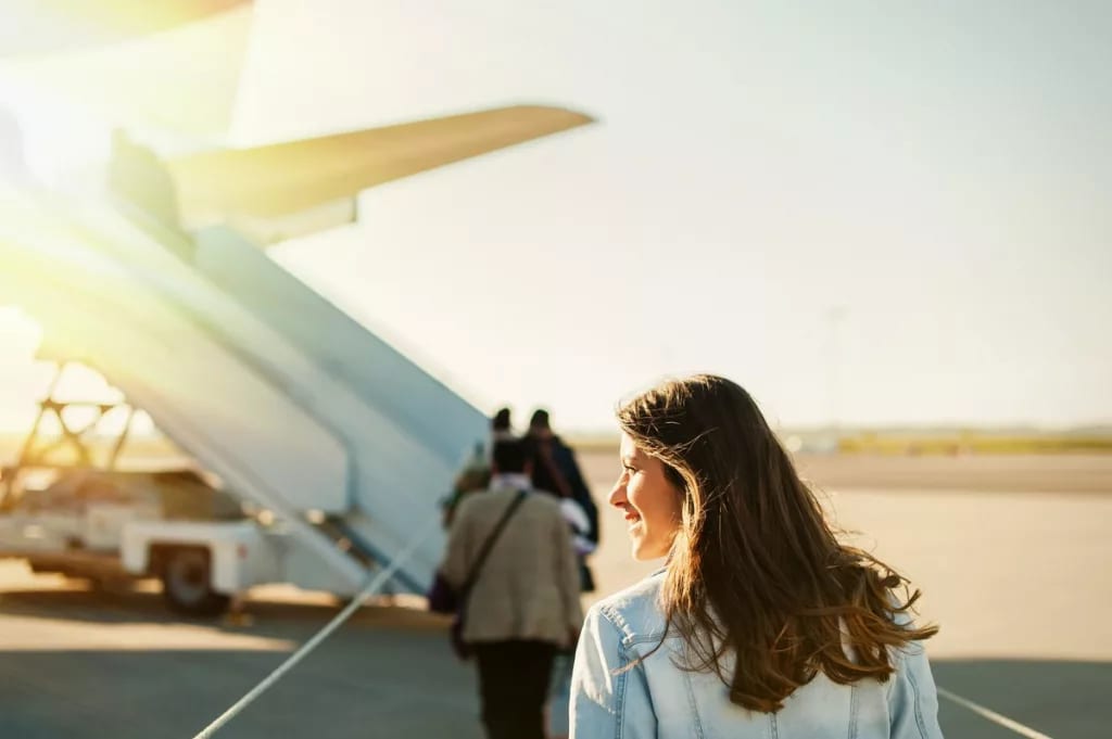 woman boarding plane outside.width .jpg