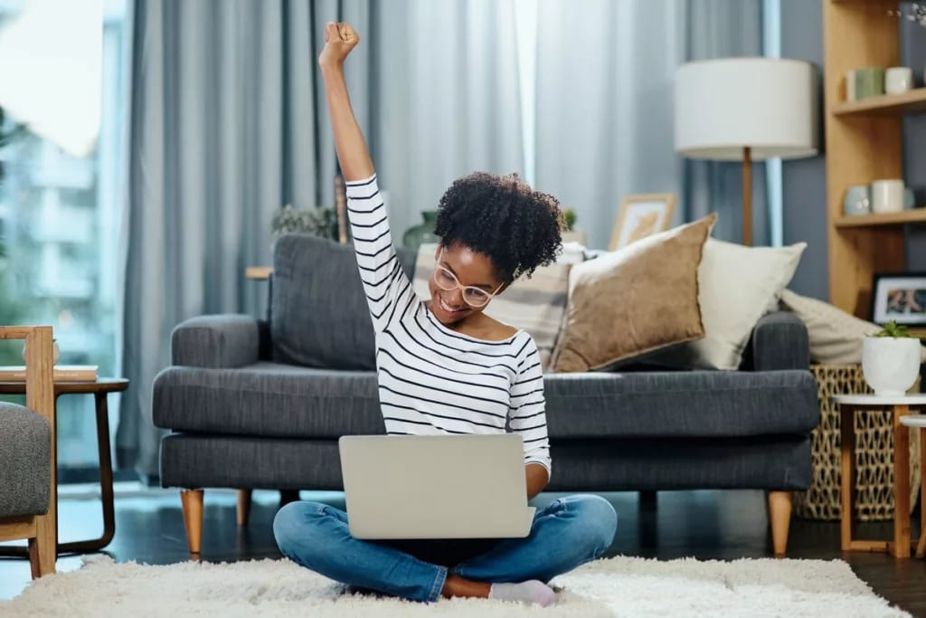 woman on laptop celebrating rLixvEH.width .jpg
