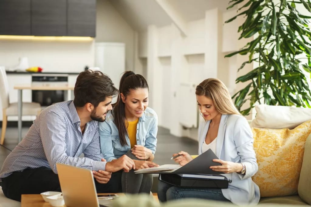 Couple signing paperwork with realtor uksbQZ.width .jpg