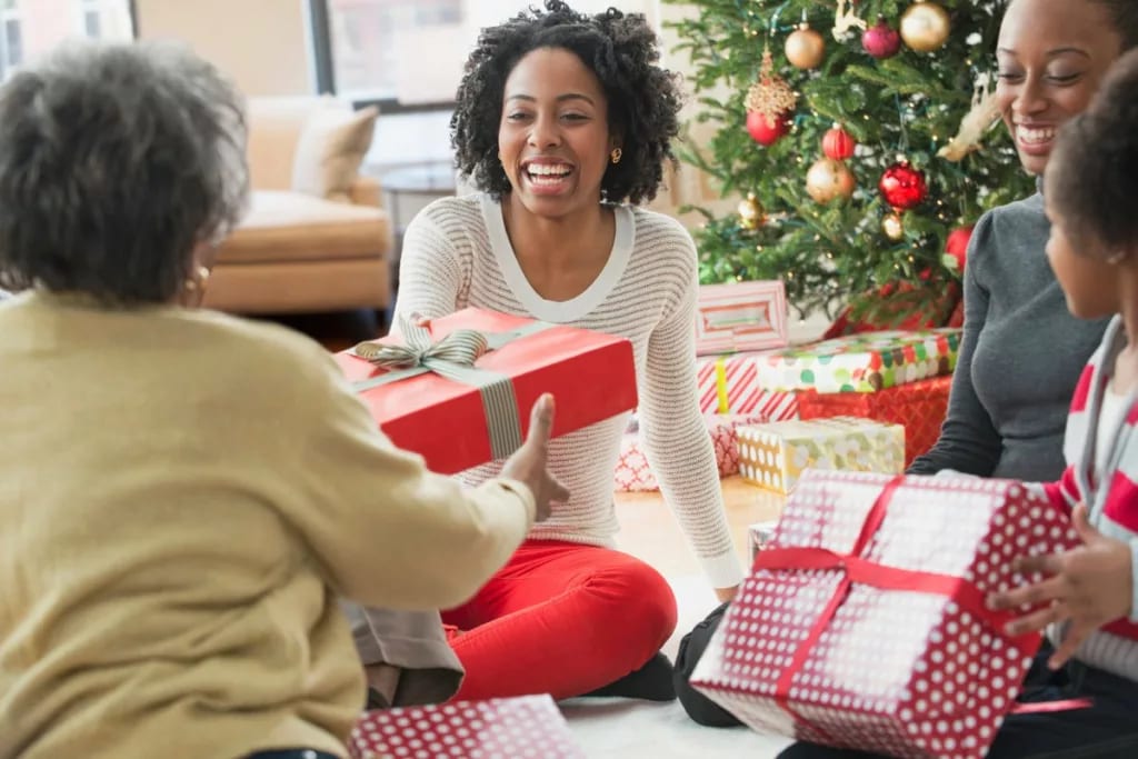 Family passing around Christmas gifts APo.width .jpg