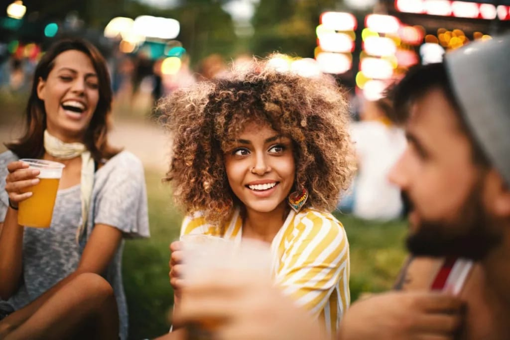 Friends drinking beer at summer concert UeeF.width .jpg
