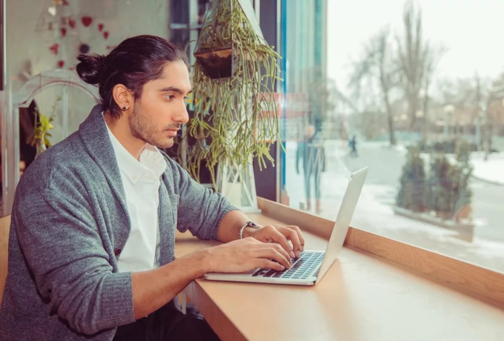 Man on laptop in cafe ateKKd.width .jpg