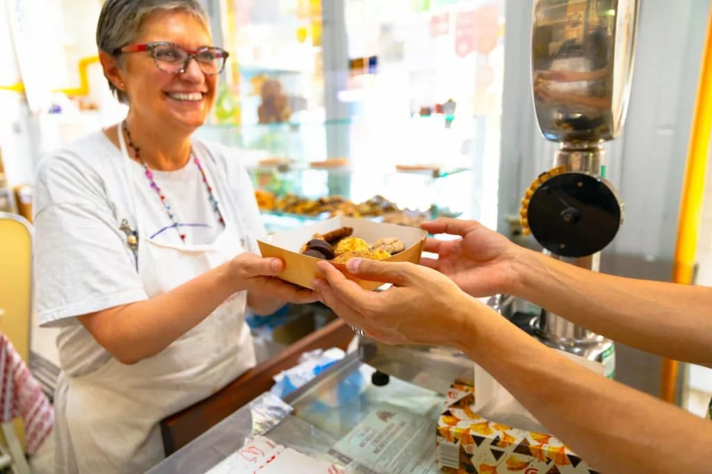 Mature woman selling a box of baked goods jJi.width .jpg