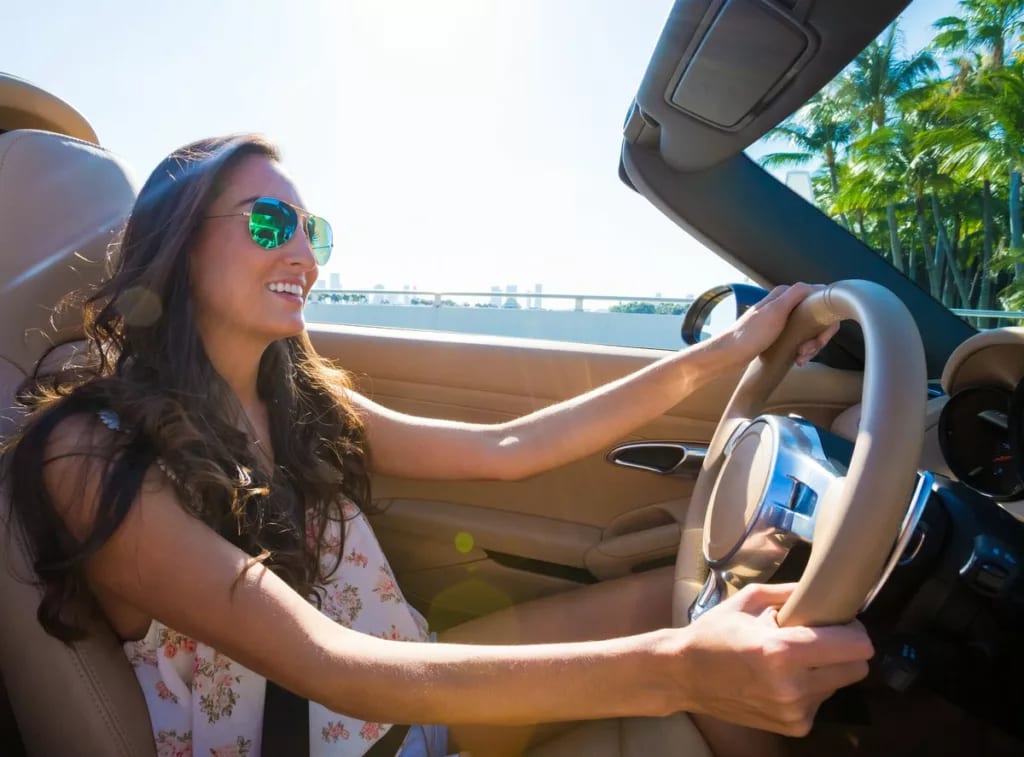 Young woman driving convertible bear the coas.width VmQWFOi.jpg