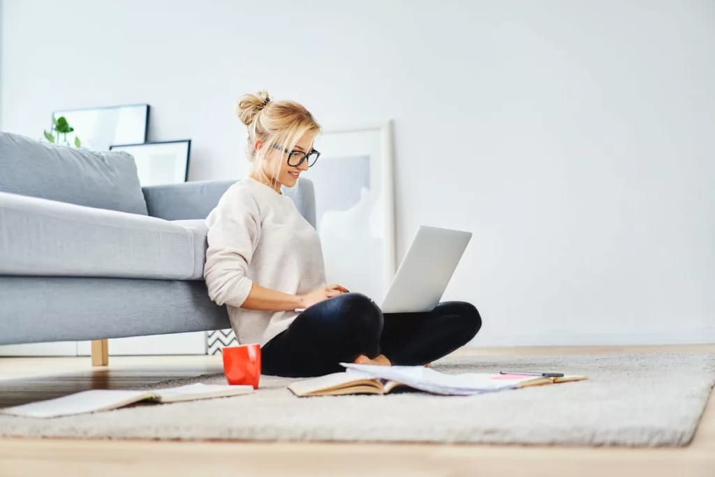 Young woman on laptop on floor foenms.width SXqJT.jpg
