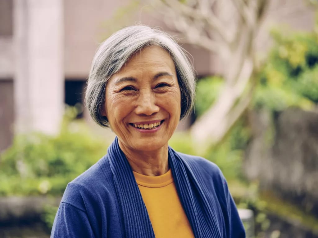 getty smiling happy outdoors blue sweater.jpg
