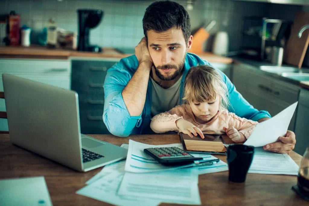 parent with toddler laptop and paperwork IjW.width .jpg