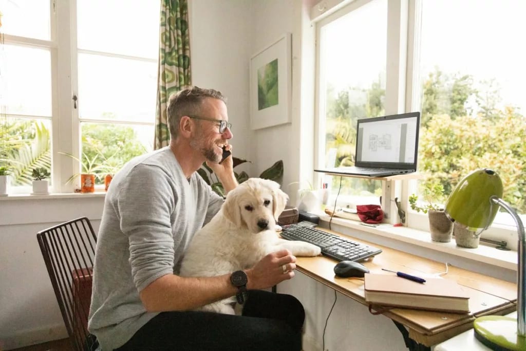 person on phone with dog on lap whDJ.width .jpg