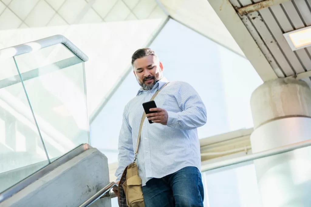 person walking with phone CeNaT.width .jpg