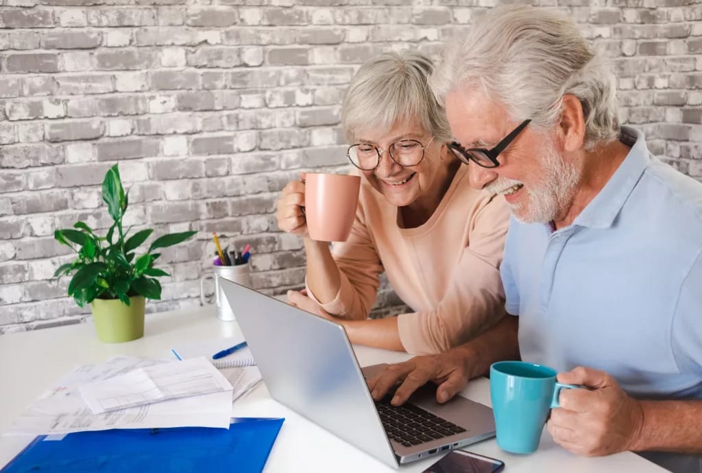 senior couple laptop smiling gettyimages .jpg