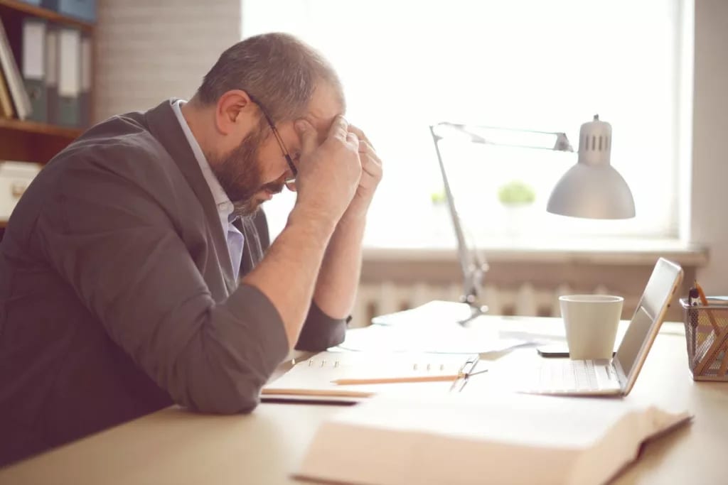 stressed man working at desk mjoTo.width .jpg