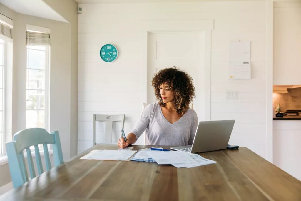 woman with laptop and notes at home RFqPxm.width .jpg