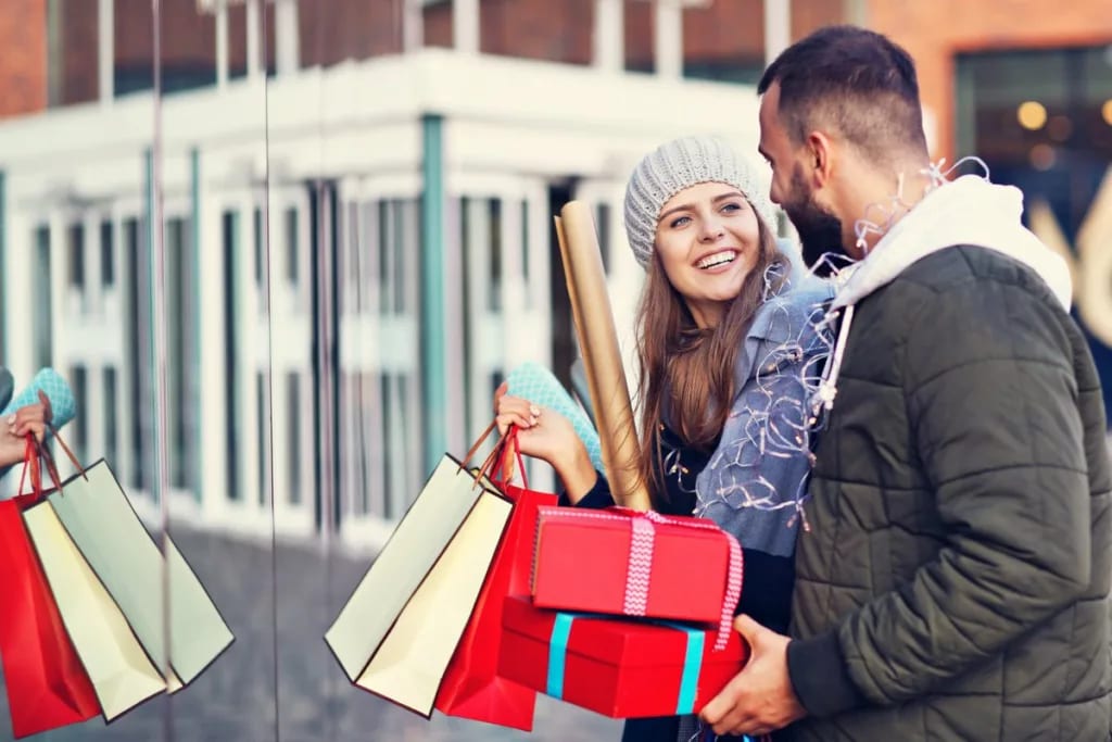 Smiling couple holiday shopping NpoPJs.width .jpg