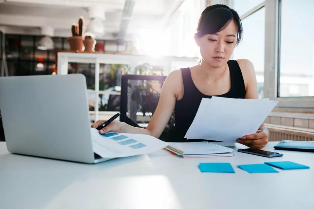 Woman reading papers in office ORTBpP.width .jpg