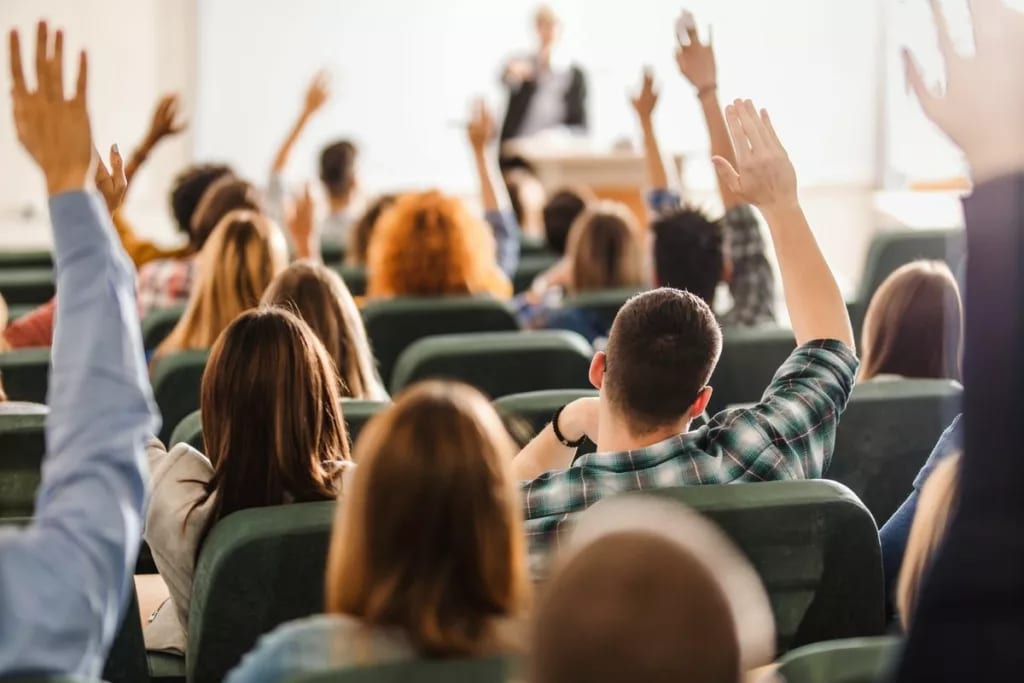 college students raising hands in lecture F.width .jpg
