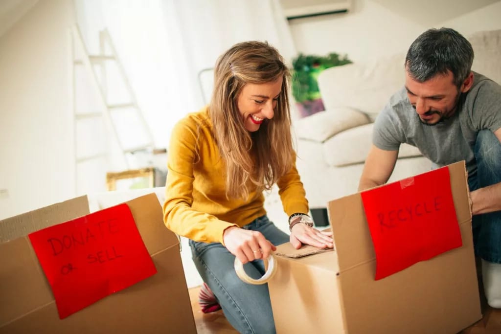 couple organizing boxes to recycle or donate .width wFcgDhz.jpg
