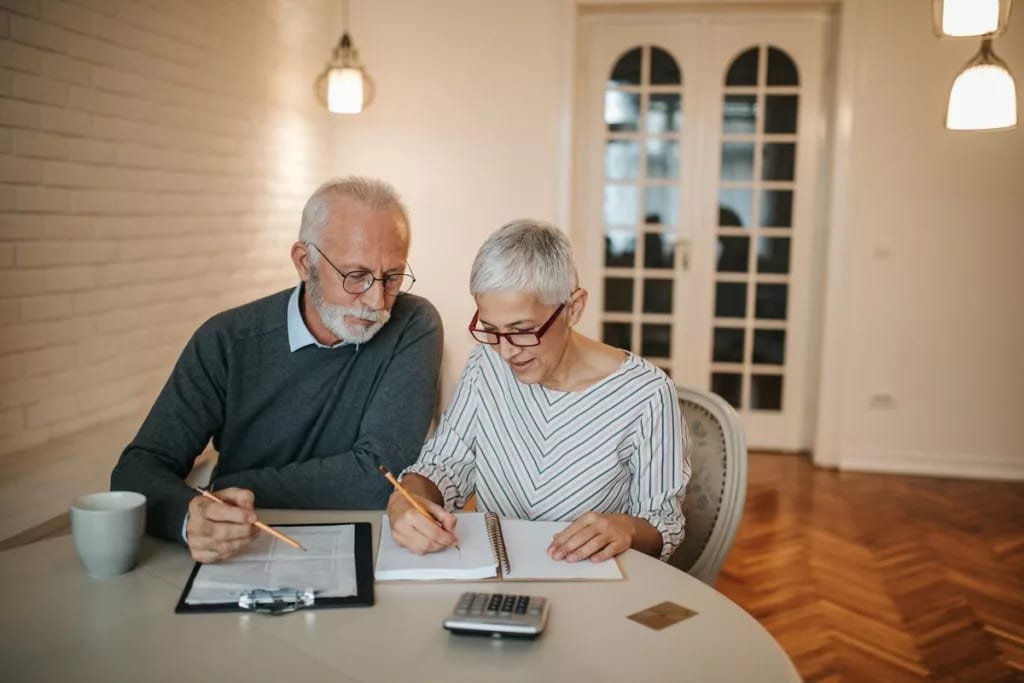 elderly couple with notebook and calculator c.width .jpg
