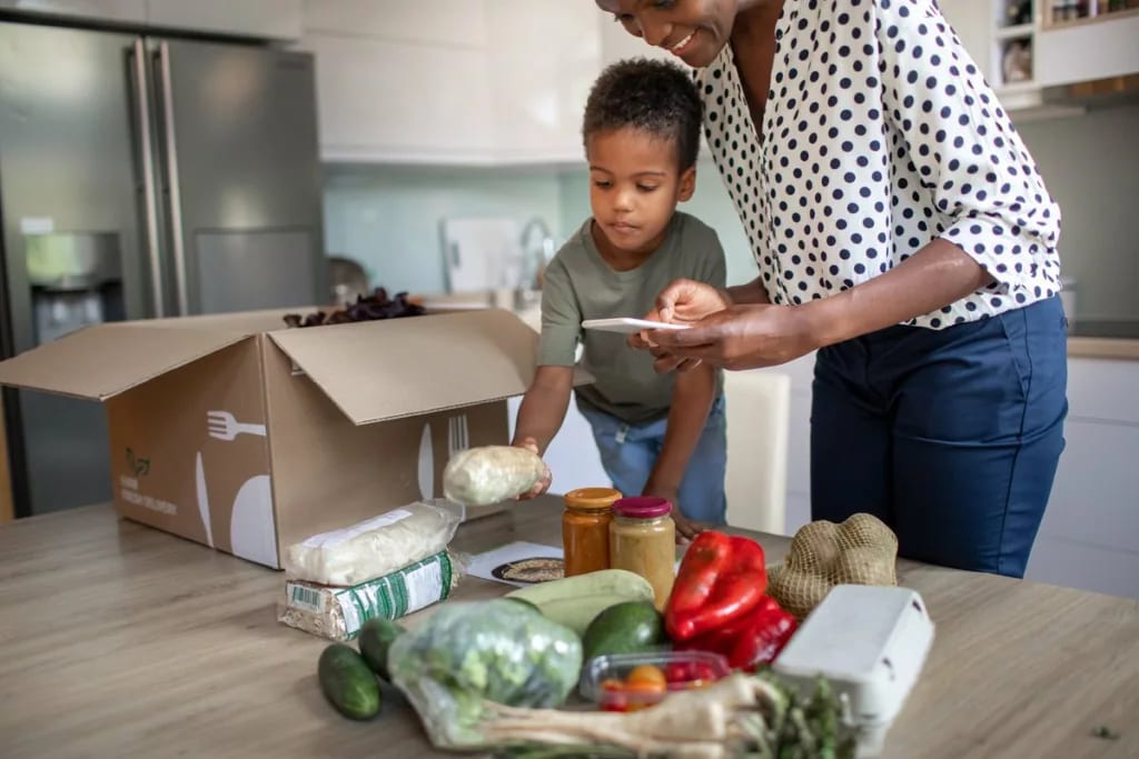 mother and son opening meal service kit.width .jpg