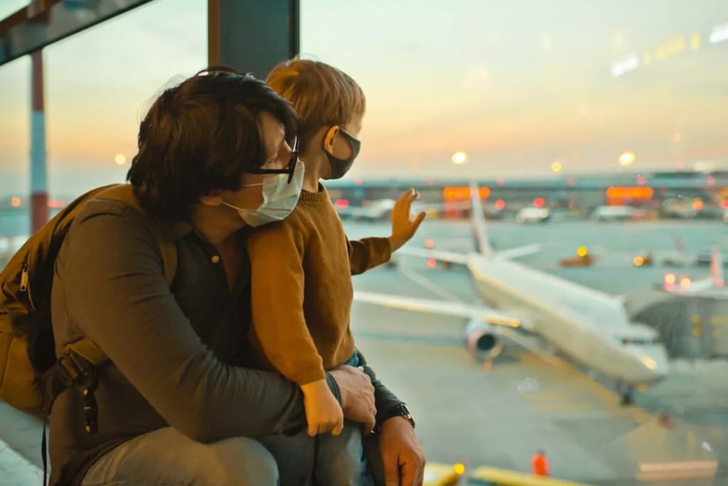 parent and child in masks at airport jOKMaM.width .jpg