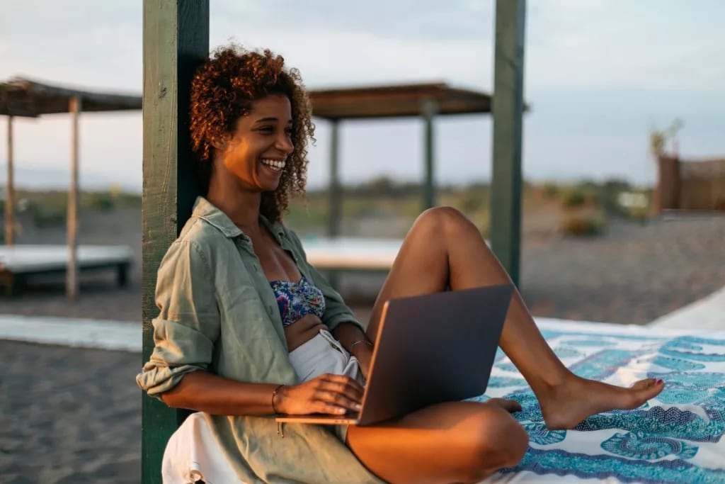 person at beach with laptop ZozlRL.width .jpg