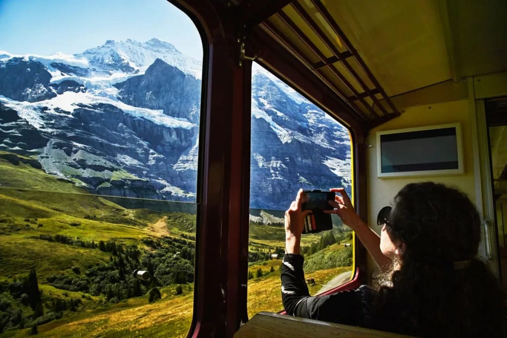 person taking photo from train lZqef.width .jpg