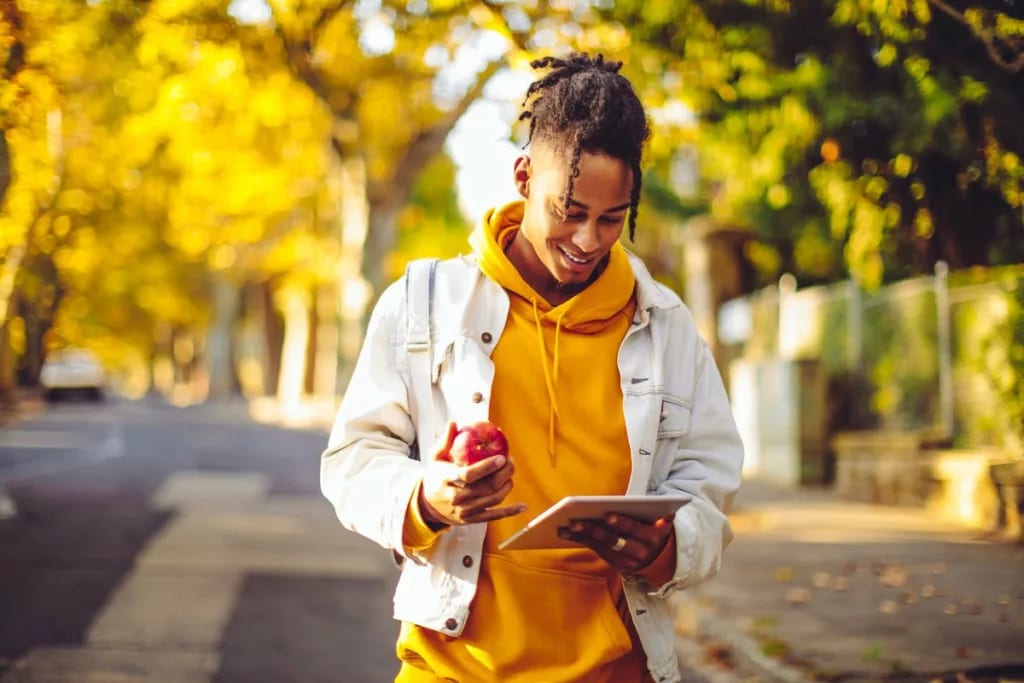 person with apple and tablet outside trVQlI.width .jpg
