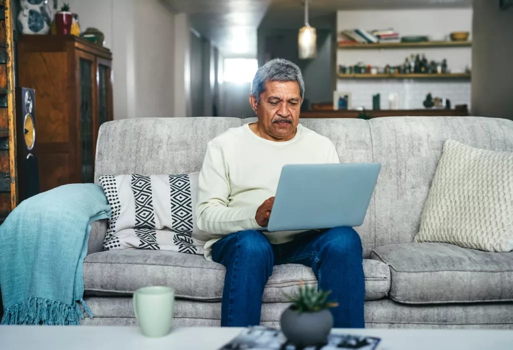senior man laptop couch gettyimages .jpg