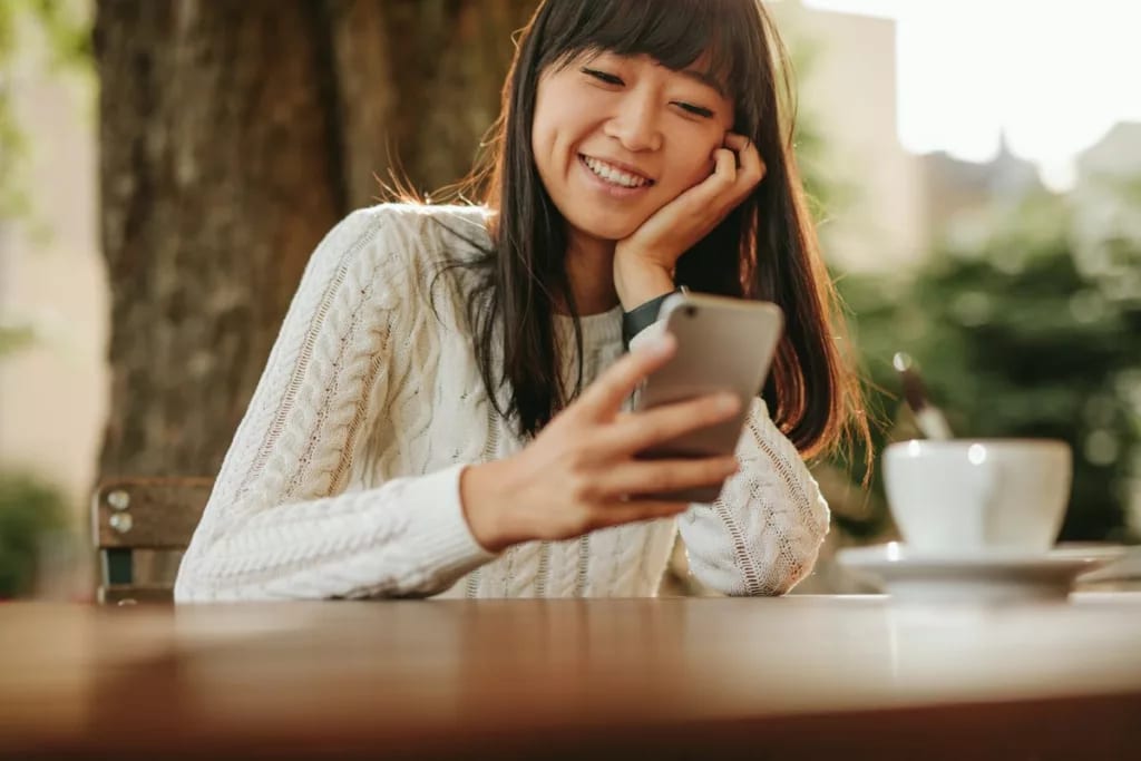 smiling person using smartphone TFngkG.width .jpg