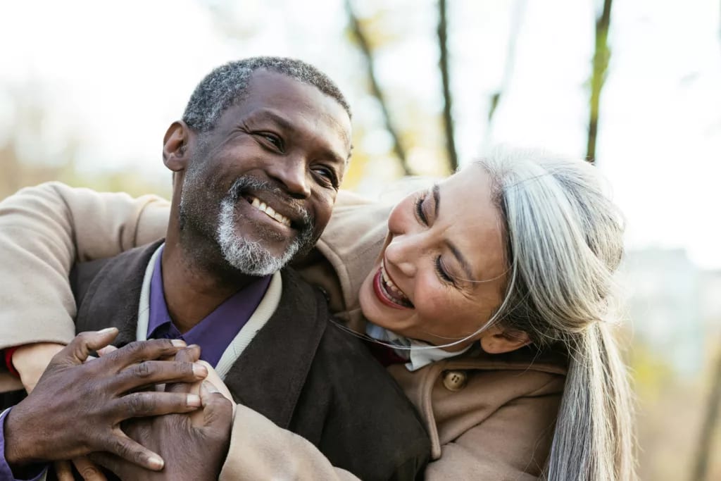 two older people hugging and smiling.jpg