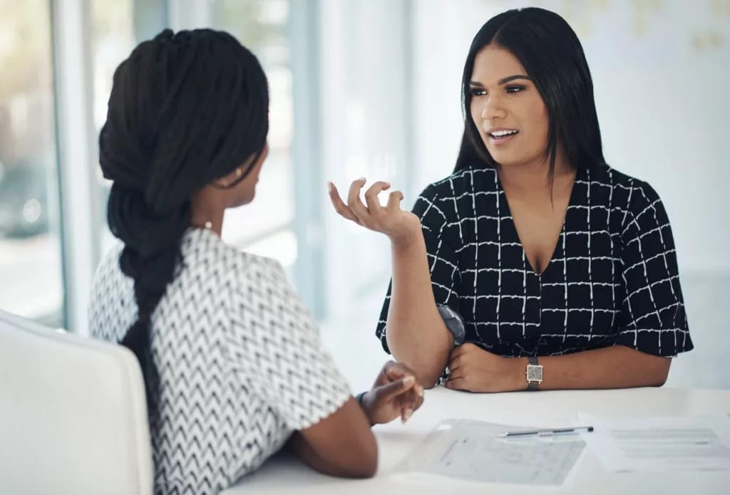 two people in office meeting PhJFen Qyrder.width .jpg