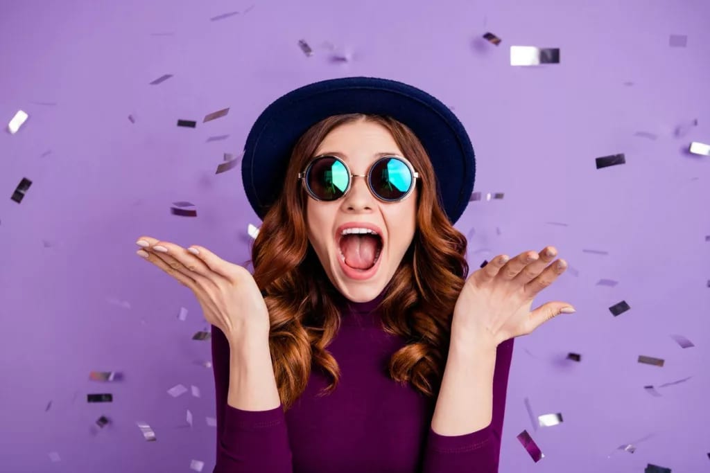 young woman celebrating confetti JJKEH.width .jpg
