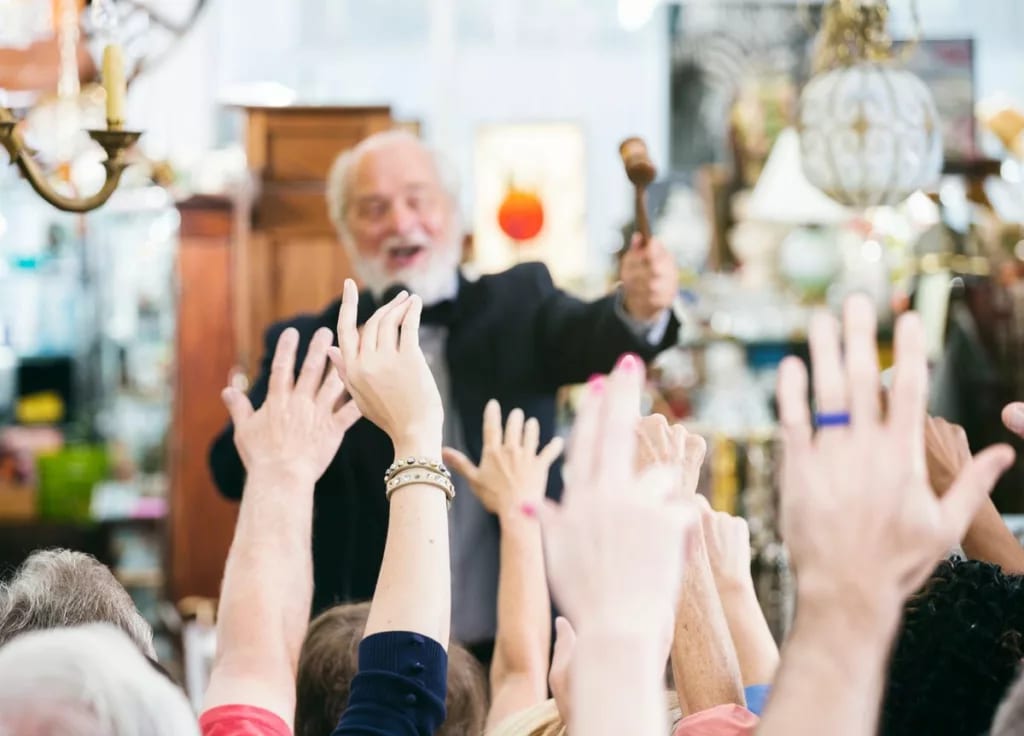Auctioneer at the head of an auction house cr.width gZUoiOh.jpg