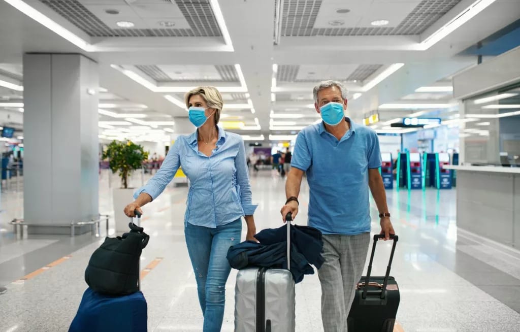 Mature couple walking through airport with lu.width LWcByxn.jpg