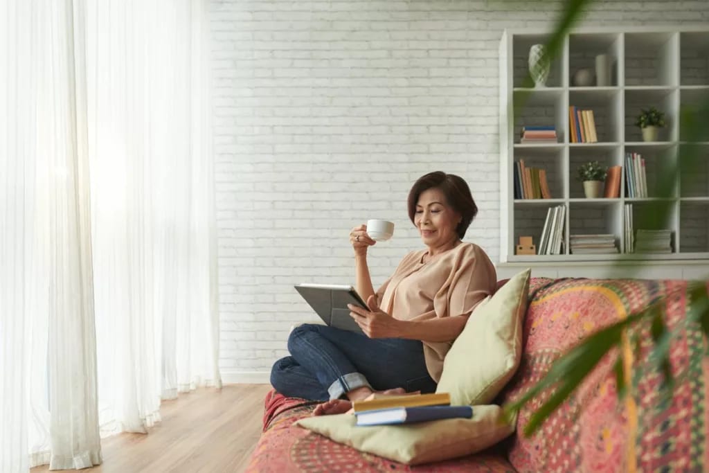 Woman drinking coffee on couch ULdGUf.width .jpg