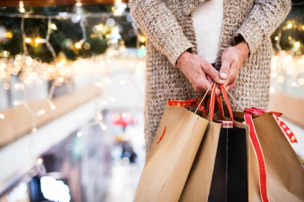 Woman holding shopping gift bags mPdZbn.width .jpg