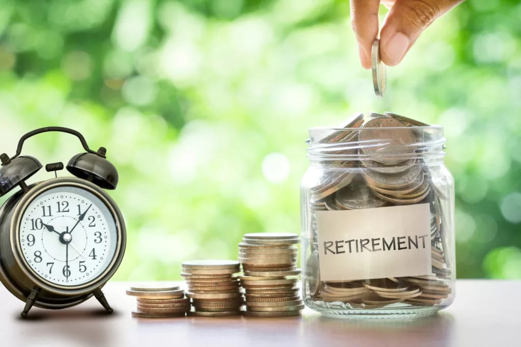 hand putting coins in glass jar with retro alarm clock.jpg