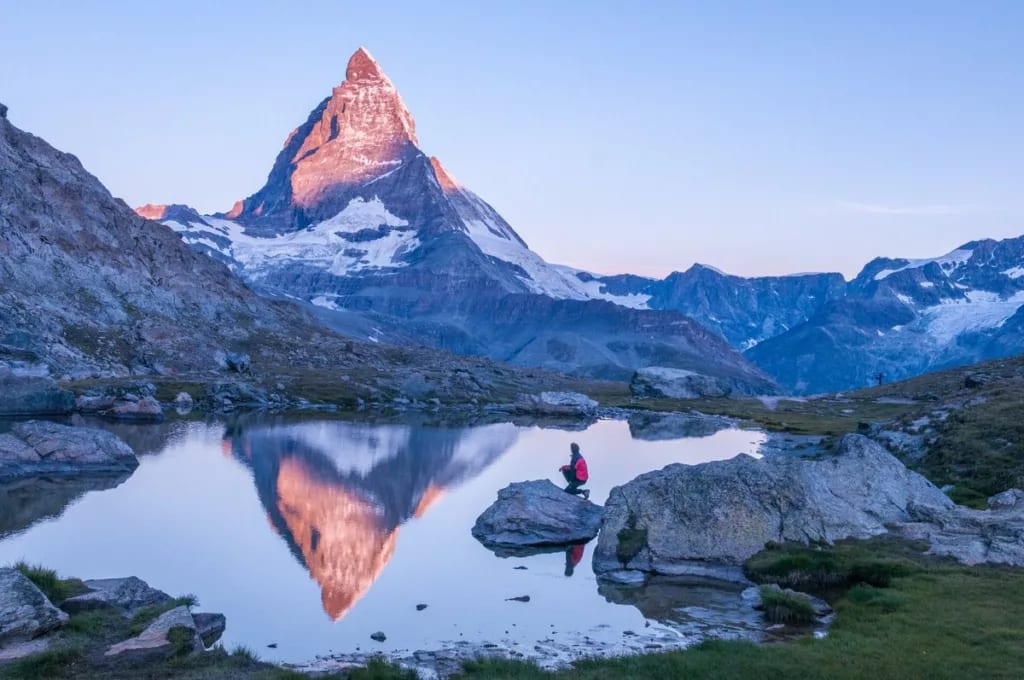 hiker in front of matterhorn mountain lake em.width .jpg