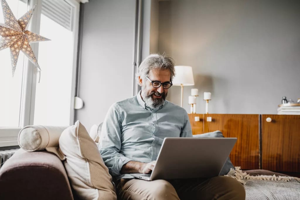 older man smiling laptop gettyimages .jpg