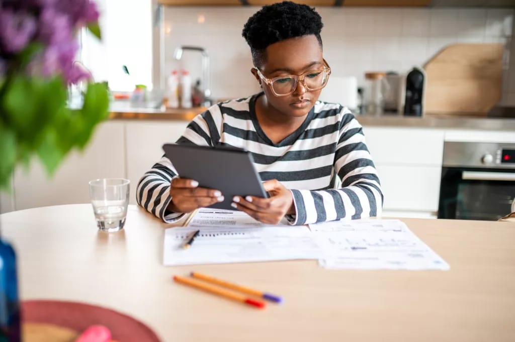 person holding tablet and looking at documents.jpg