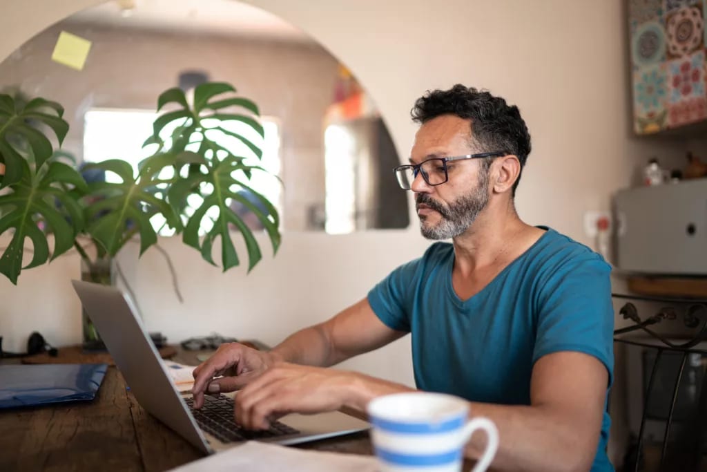 person using a laptop at home.jpg