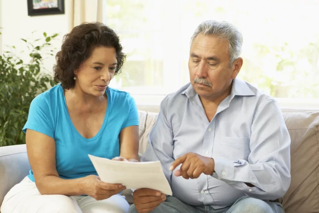 senior couple pointing at document.jpg