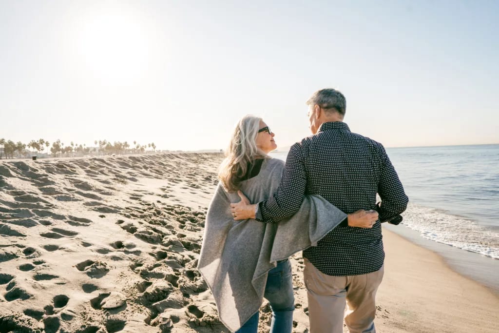 two people walking on the beach hugging.jpg