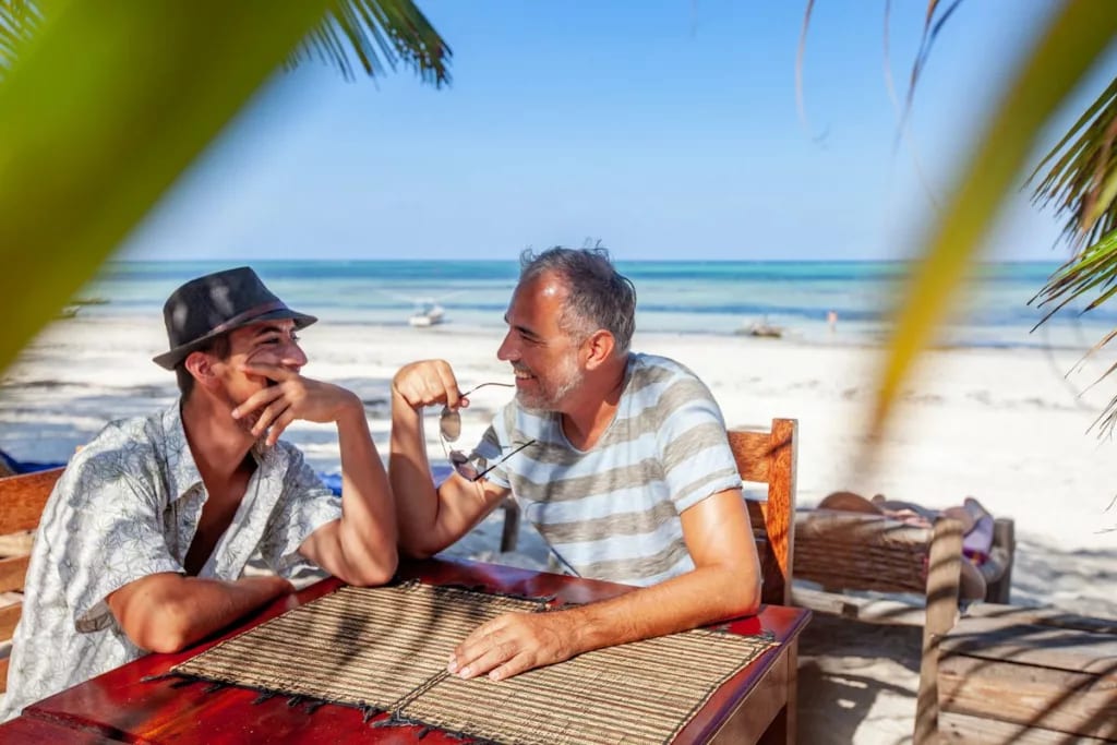 two people at beachside table TMuBhy.width .jpg