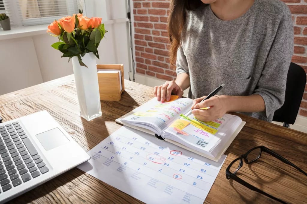 women at desk with calendar and planner.width .jpg