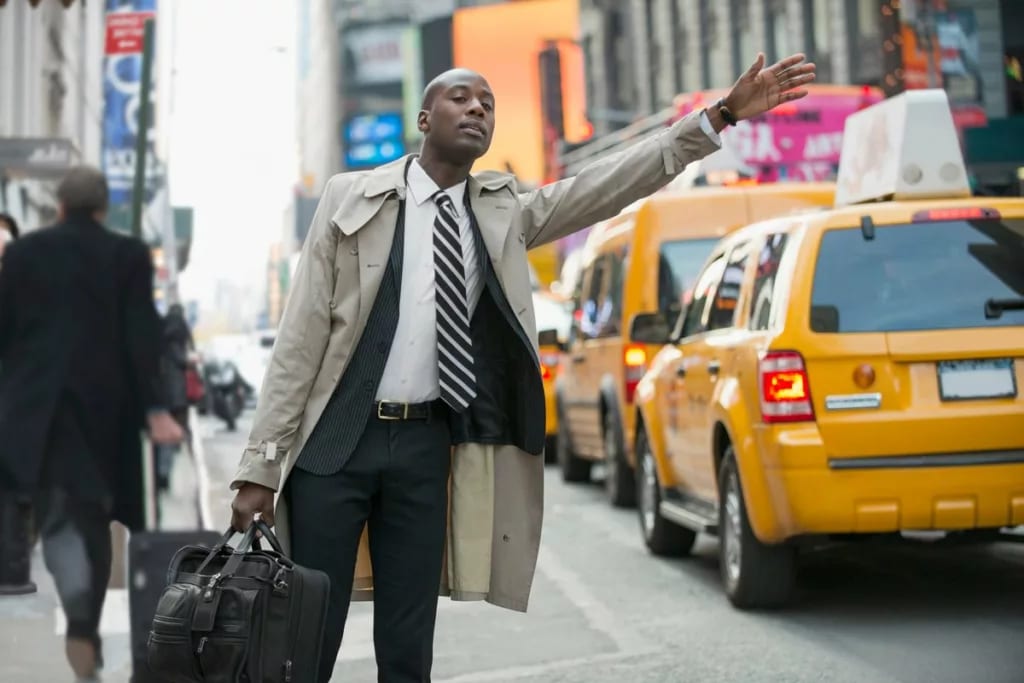Businessman hailing a cab in the city OhTGMP.width .jpg