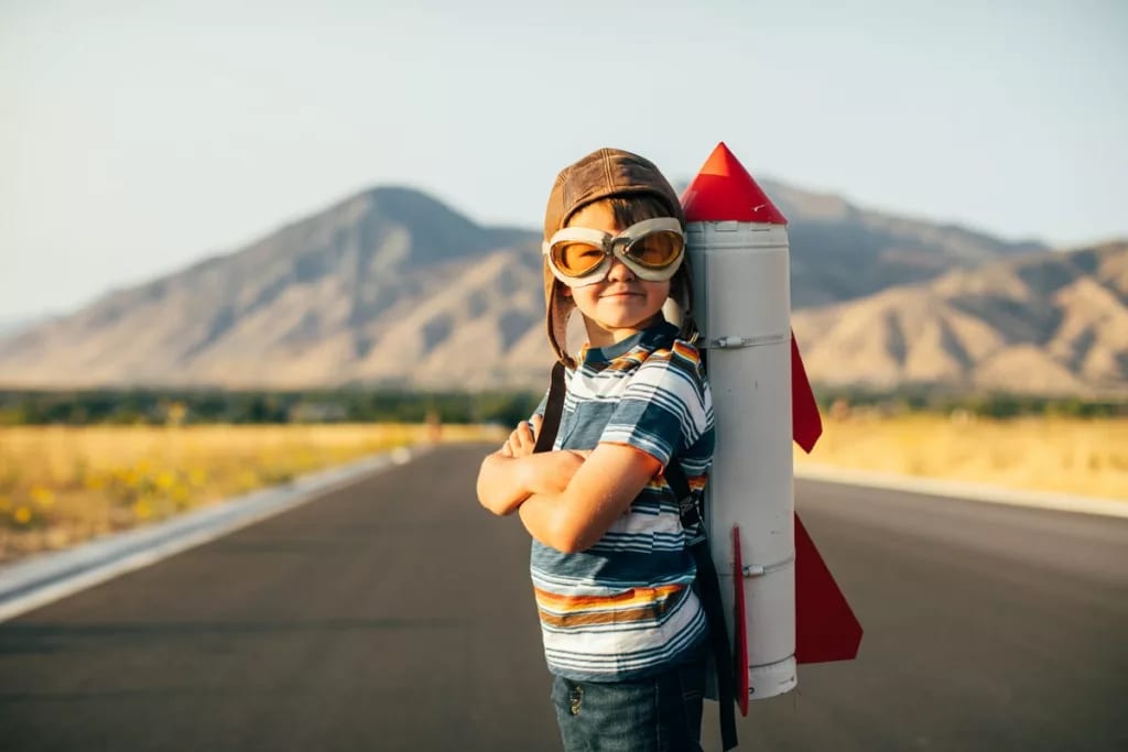 Child standing on a rural road with a toy roc.width .jpg