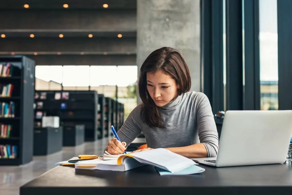 Female college student studying library.width .jpg